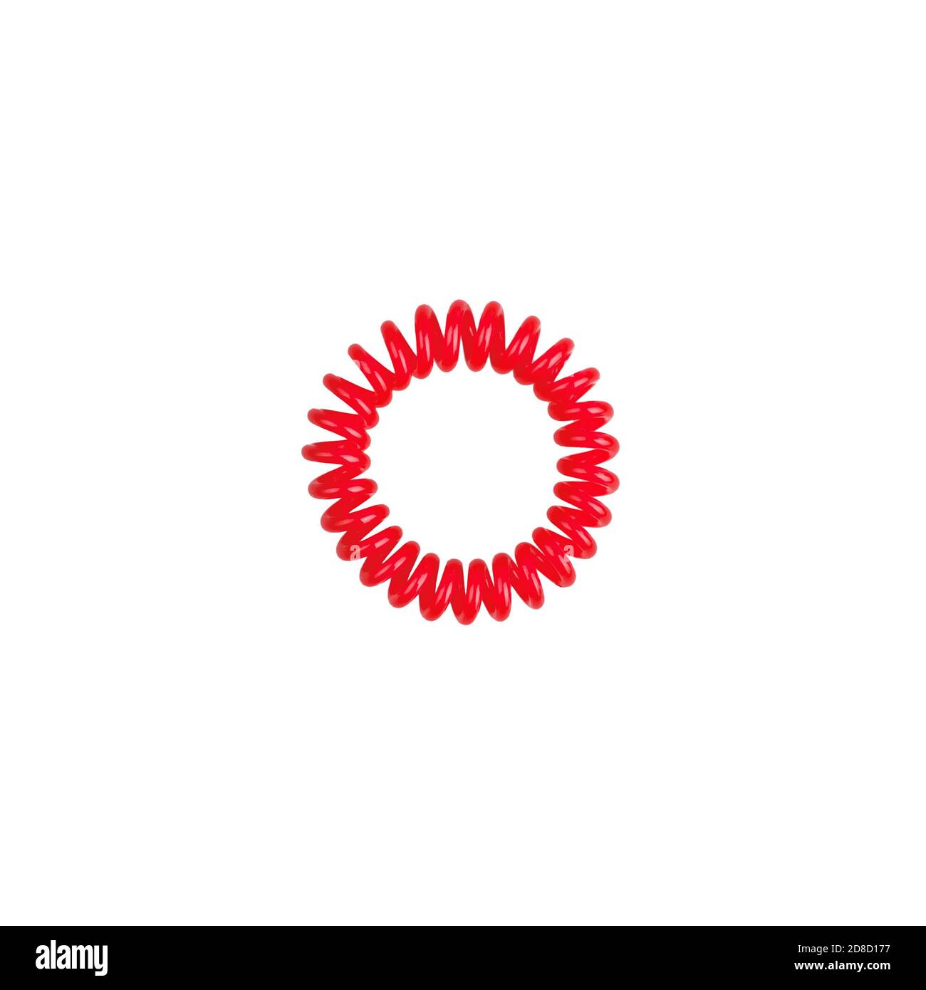 Red scrunchy on white background isolated closeup, spiral elastic scrunchie, circle flexible plastic hair band, one round rubber barrette, hairstyle Stock Photo