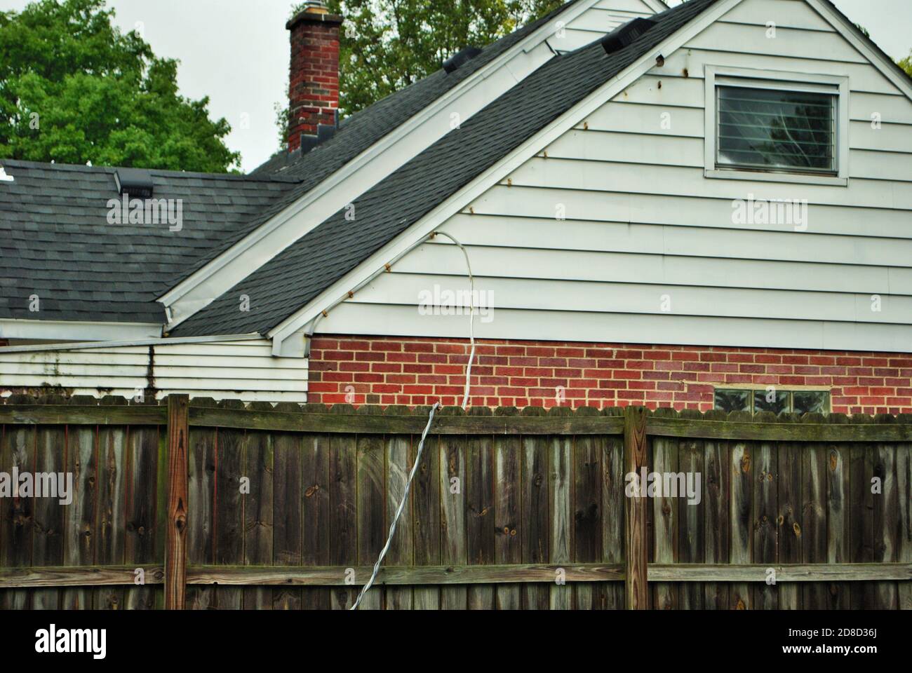 Dangerous live downed power line draped across fence Stock Photo Alamy