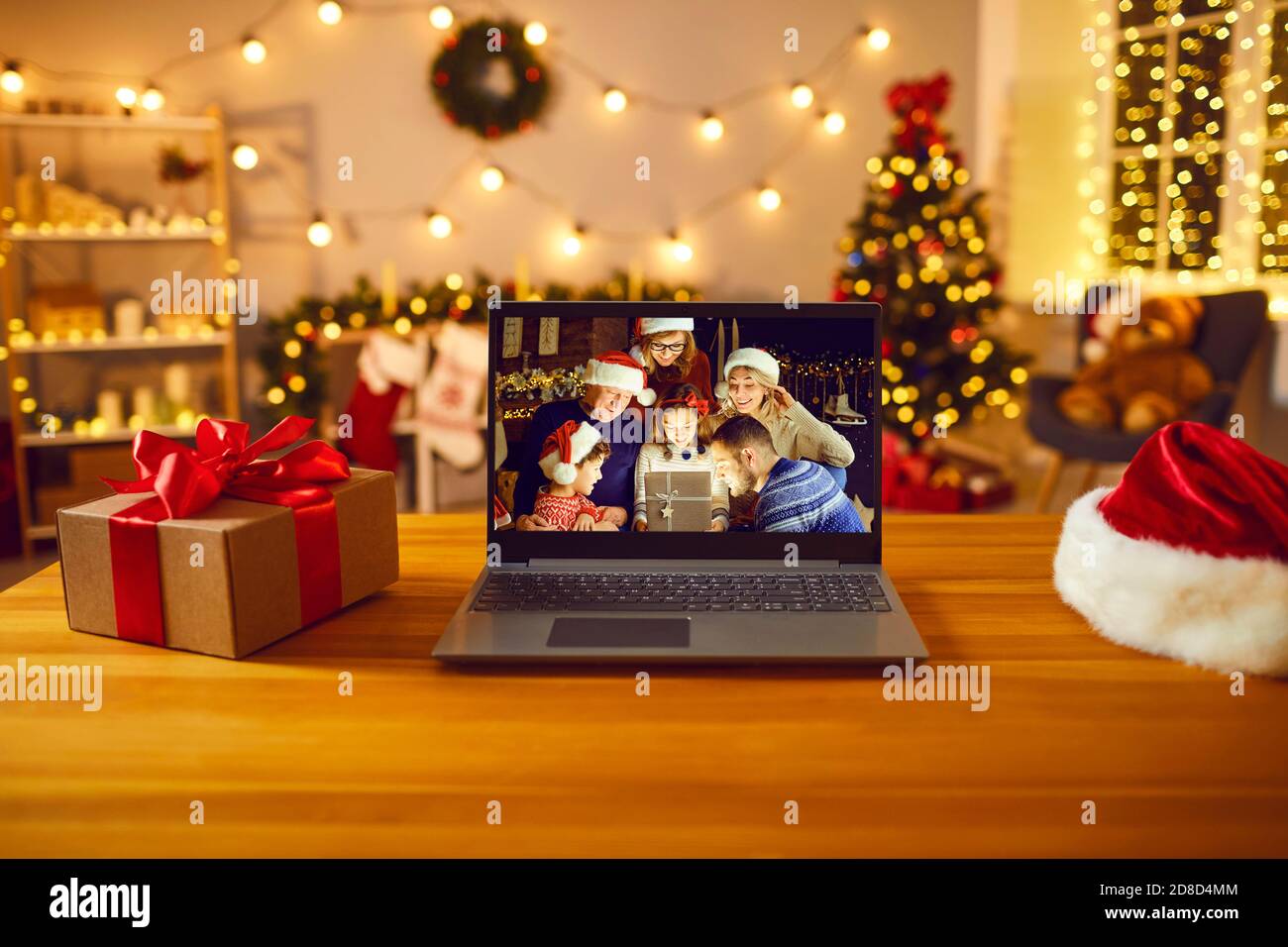 Laptop computer with happy family on the screen opening a wonderful