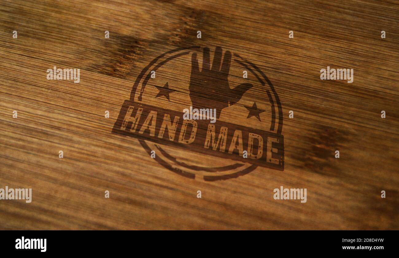 Hand made symbol stamp printed on wooden box. Home work, manufacturing, ecology, business, quality, handcraft and handmade production concept. Stock Photo