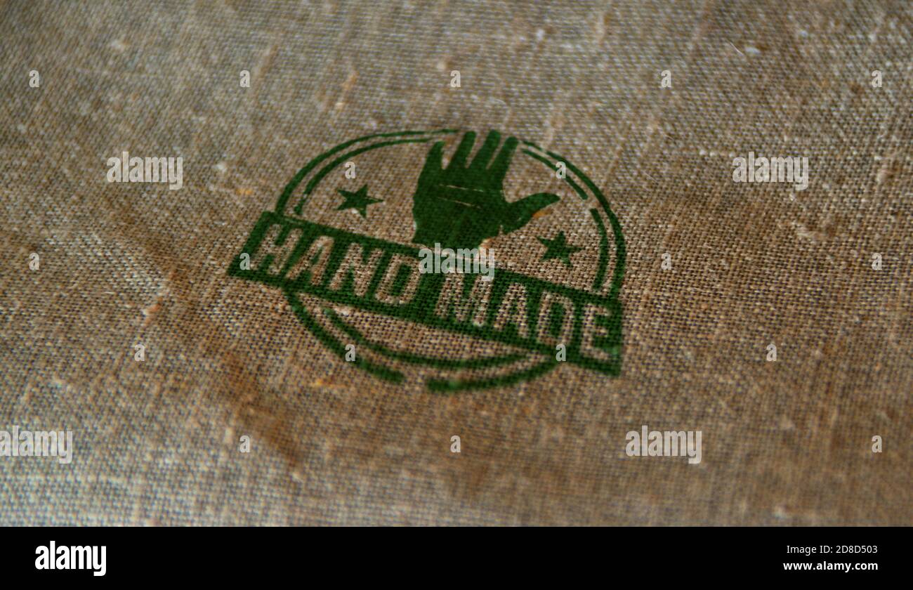 Hand made symbol stamp printed on linen sack. Home work, manufacturing, ecology, business, quality, handcraft and handmade production concept. Stock Photo