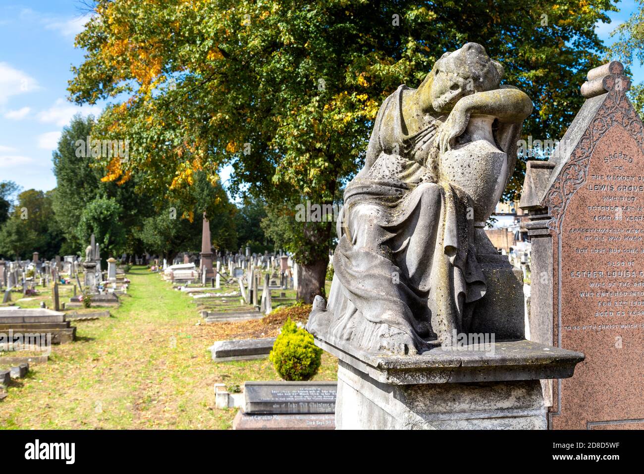 Funerary monument of mourning woman at Kensal Green Cemetery in autumn, London, UK Stock Photo