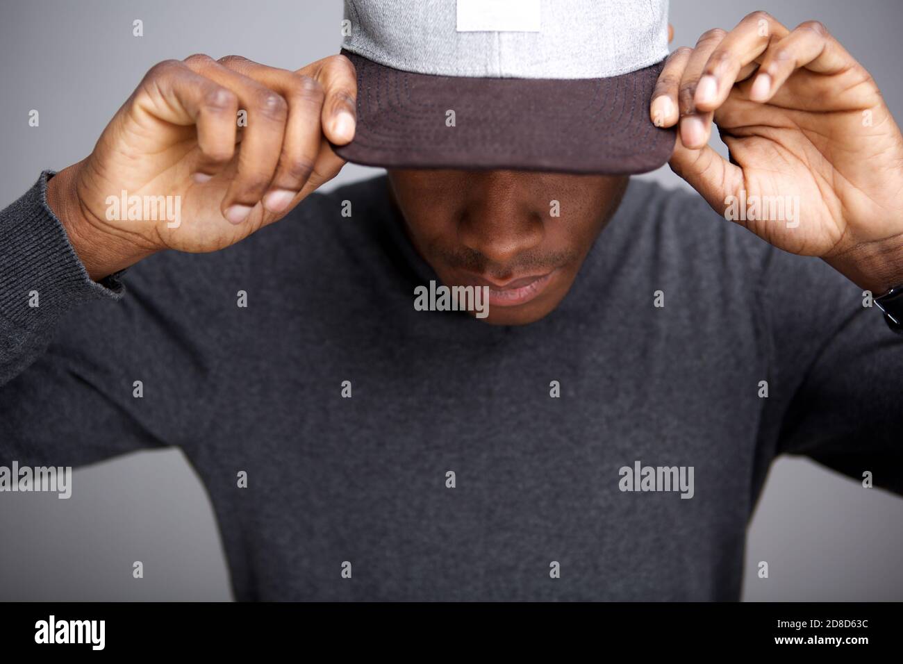 Close up portrait of cool african american male model with hat looking