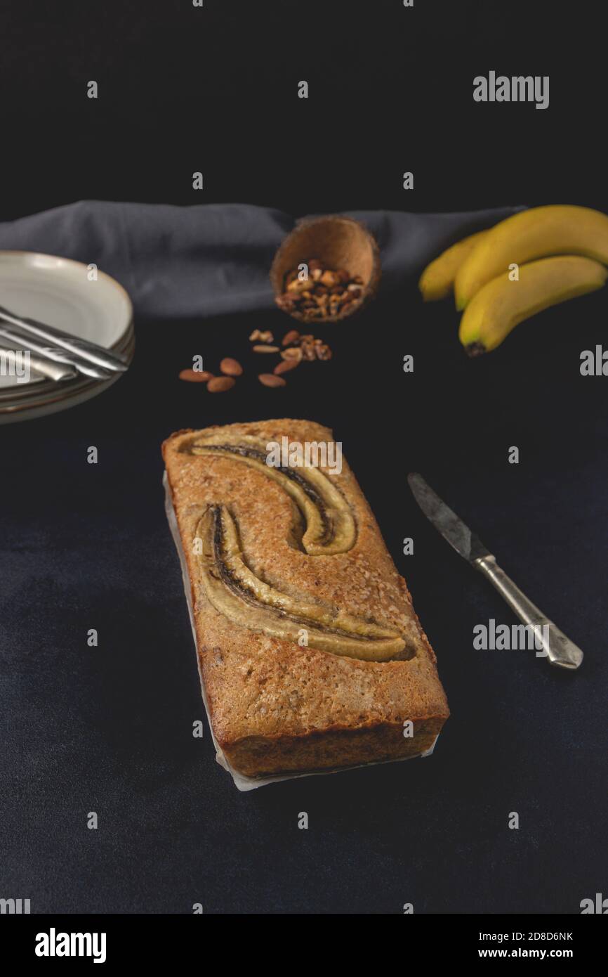 Banana nut bread loaf isolated on the dark background. Banana bread