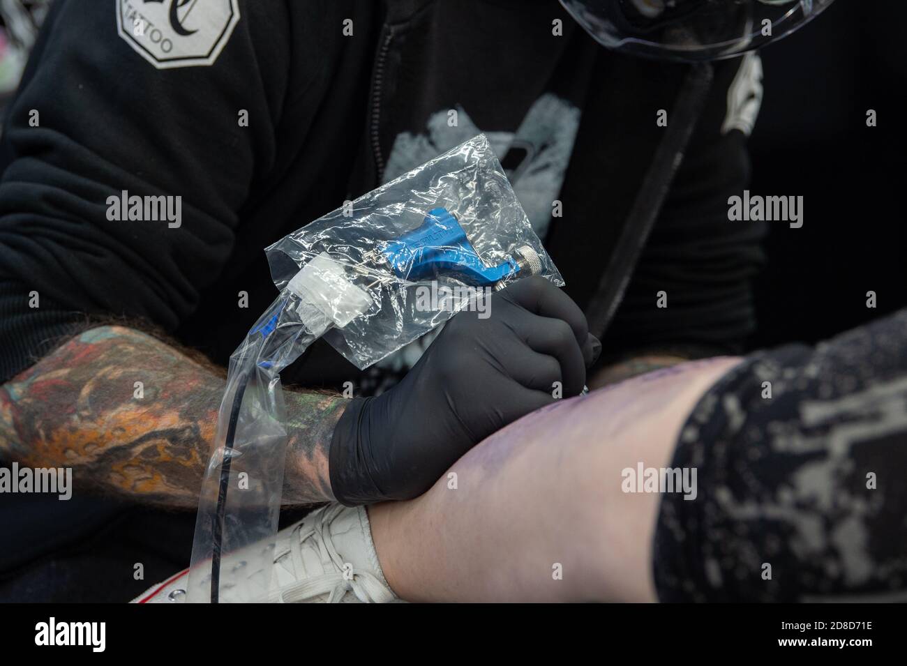 Tattoo artists work at Bodycraft Tattoo and Piercing Studios in Nottingham before being forced to close when Tier 3 restrictions come into place from 0001 on Friday Stock Photo Alamy