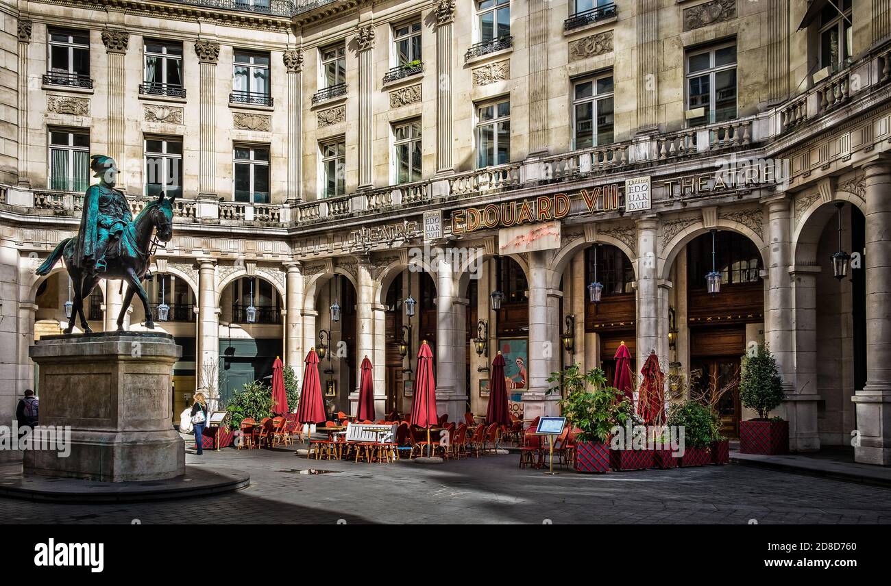 Paris, France, Feb 2020, Edouard VII square with the statue and the theatre of the same name and the terrace of Café Guitry Stock Photo