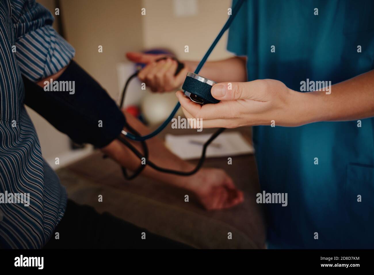 Closeup of young female doctor hands measuring patient blood pressure Stock Photo