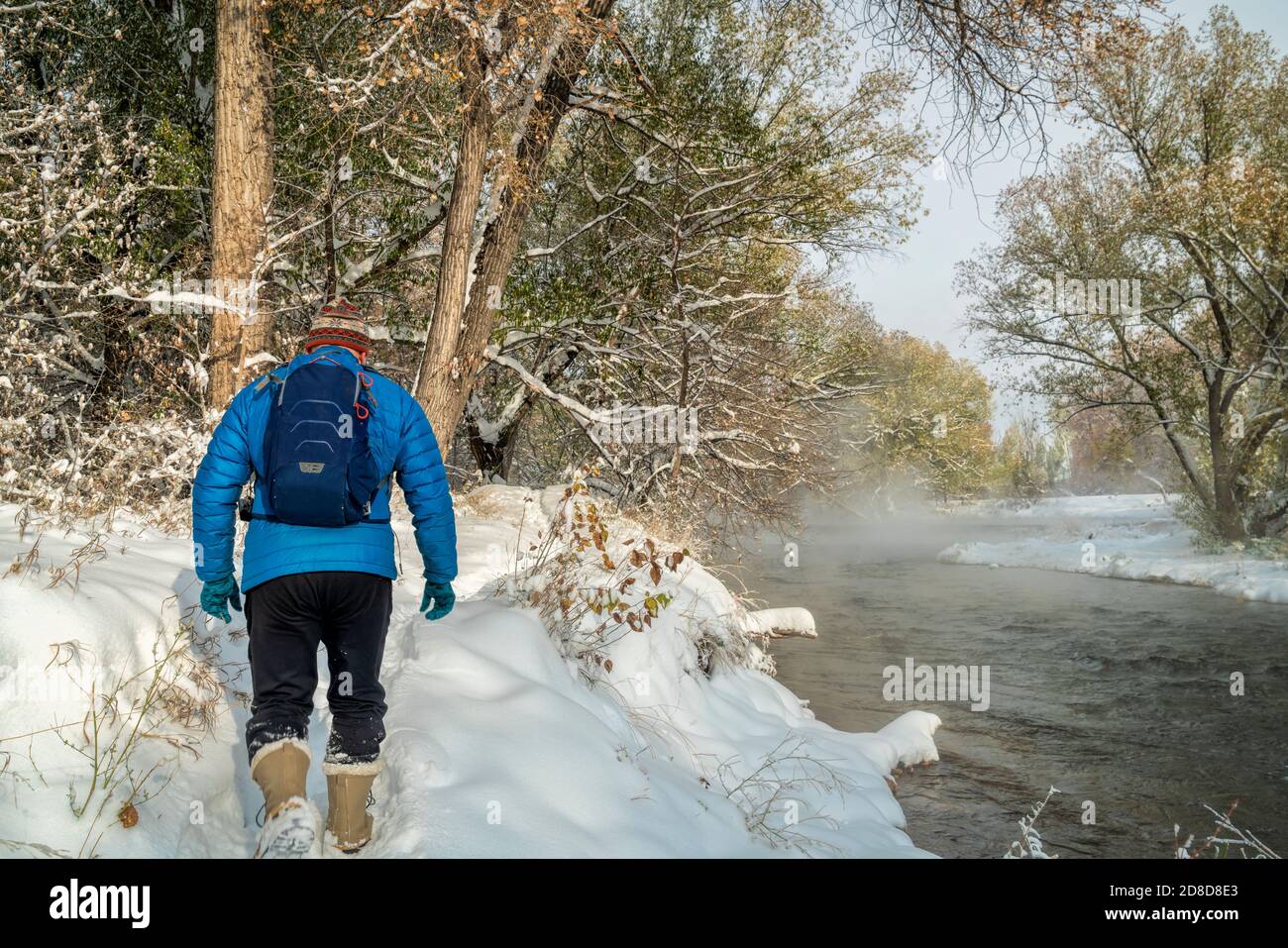 senior male is hiking along the Poudre River in Fort Collins, Colorado foggy fall scenery with