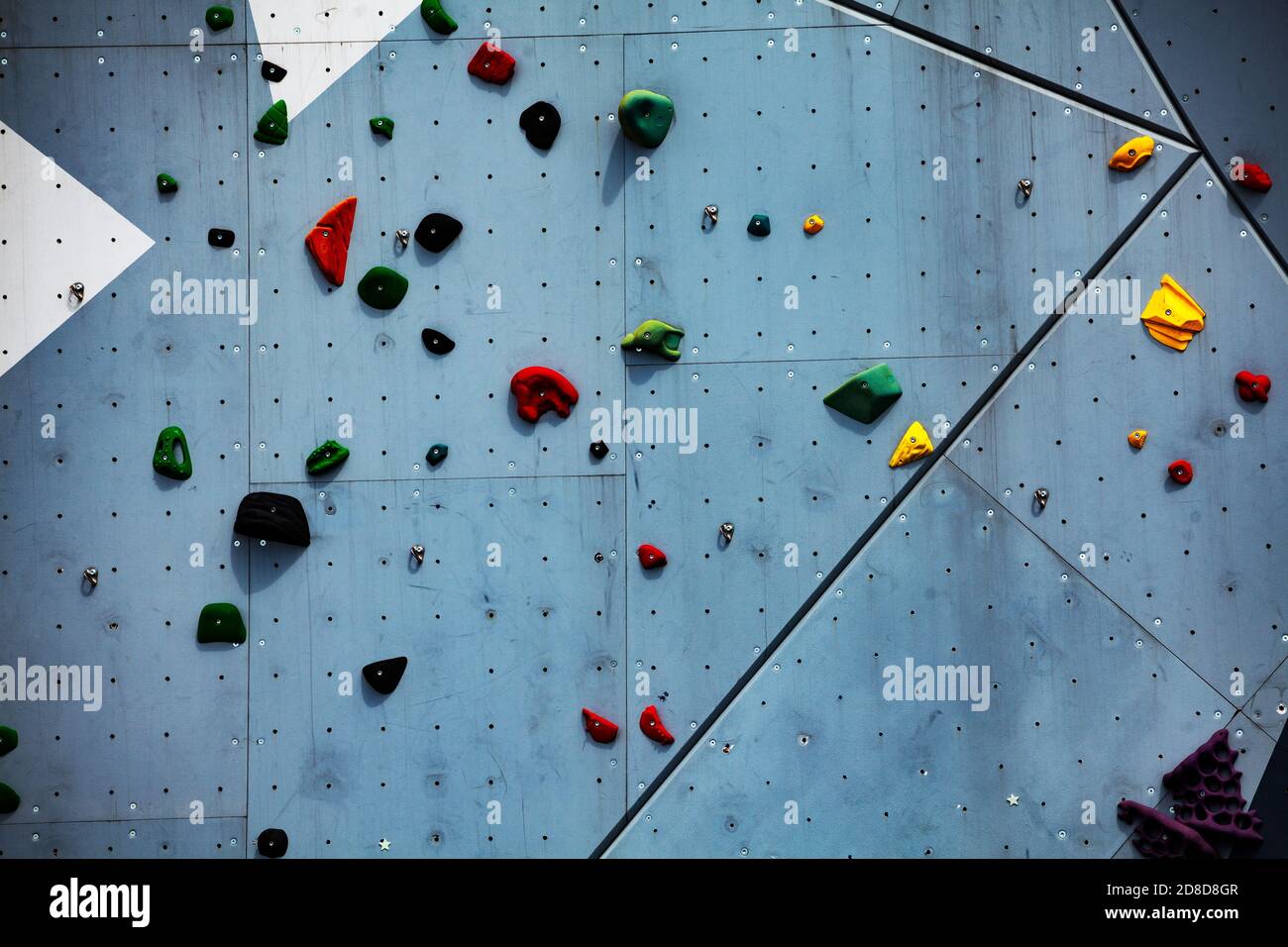 Street climbing wall close-up view with color grips Stock Photo