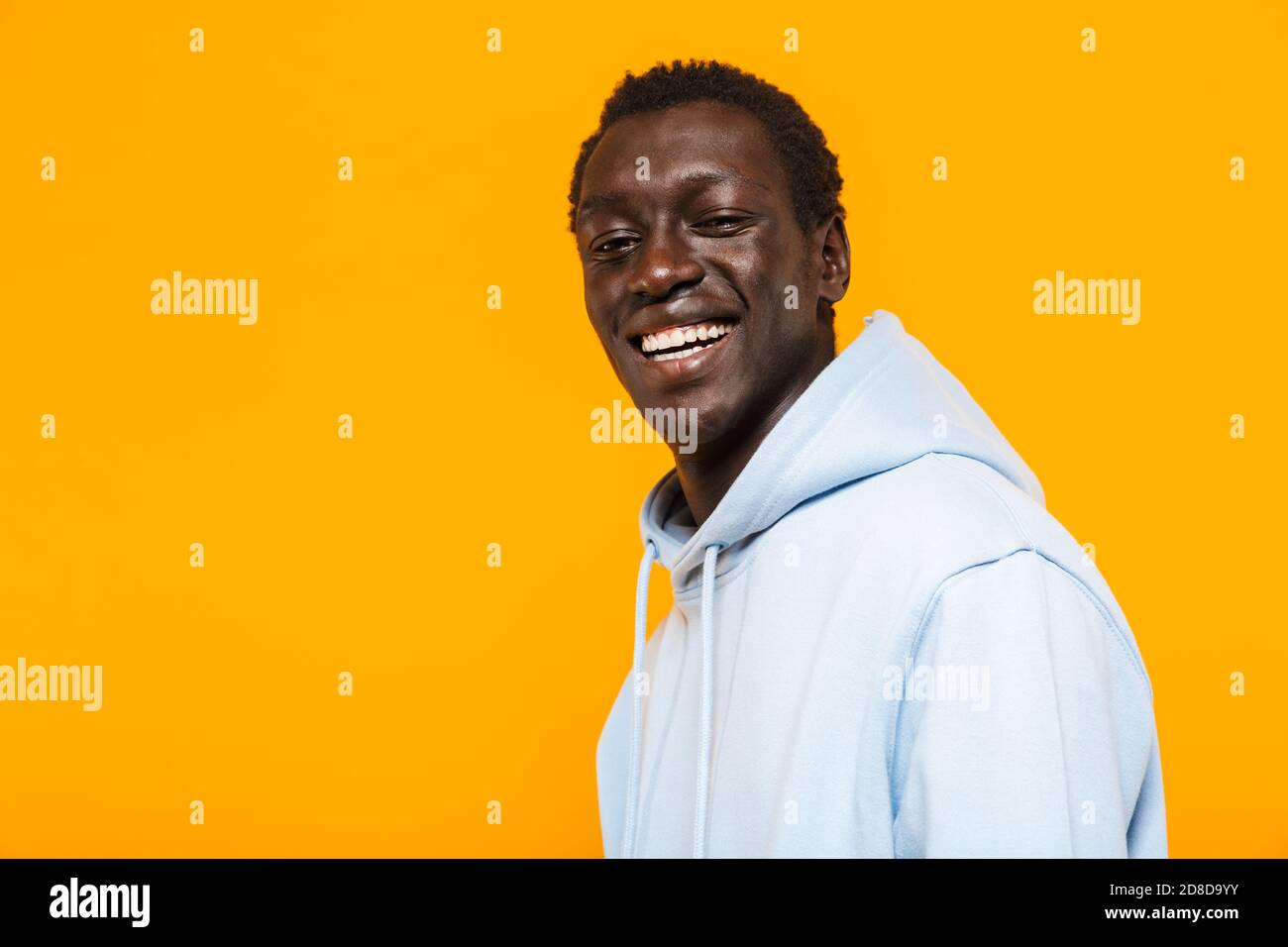 Image of happy african american guy in streetwear hoodie standing and ...