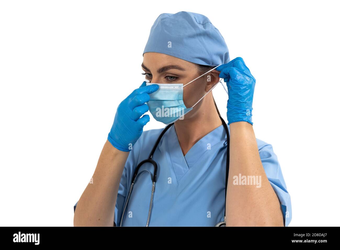 Female surgeon wearing face mask against white background Stock Photo ...
