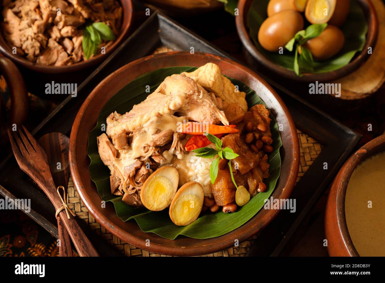 Nasi Gudeg. Javanese meal of rice with jackfruit stew, chicken curry, and spicy cattle skin cracker stew Stock Photo