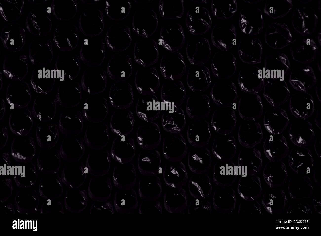 indigo space violet sparkling bubbles, brilliant plastic cellophane drops texture waste recycling background Stock Photo