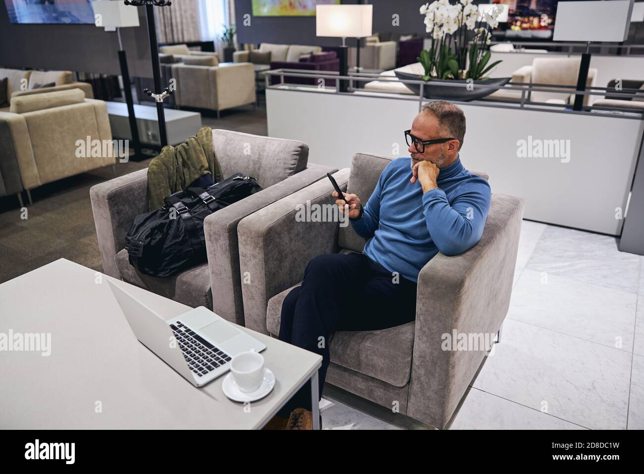 Man in eyeglasses reading a text message Stock Photo