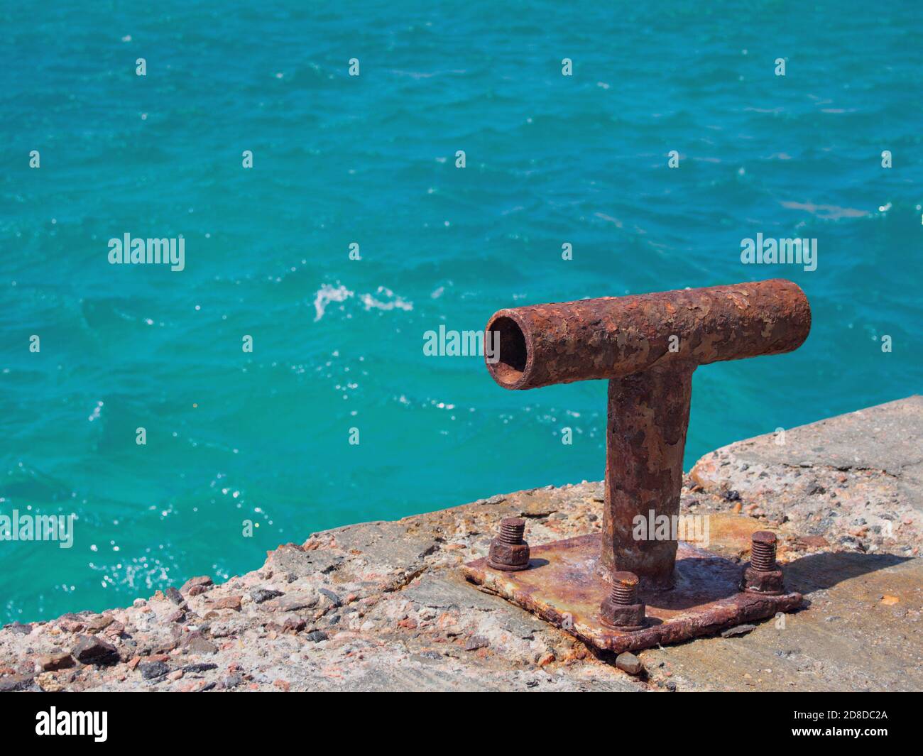 Old iron mooring bollard on the berth Stock Photo