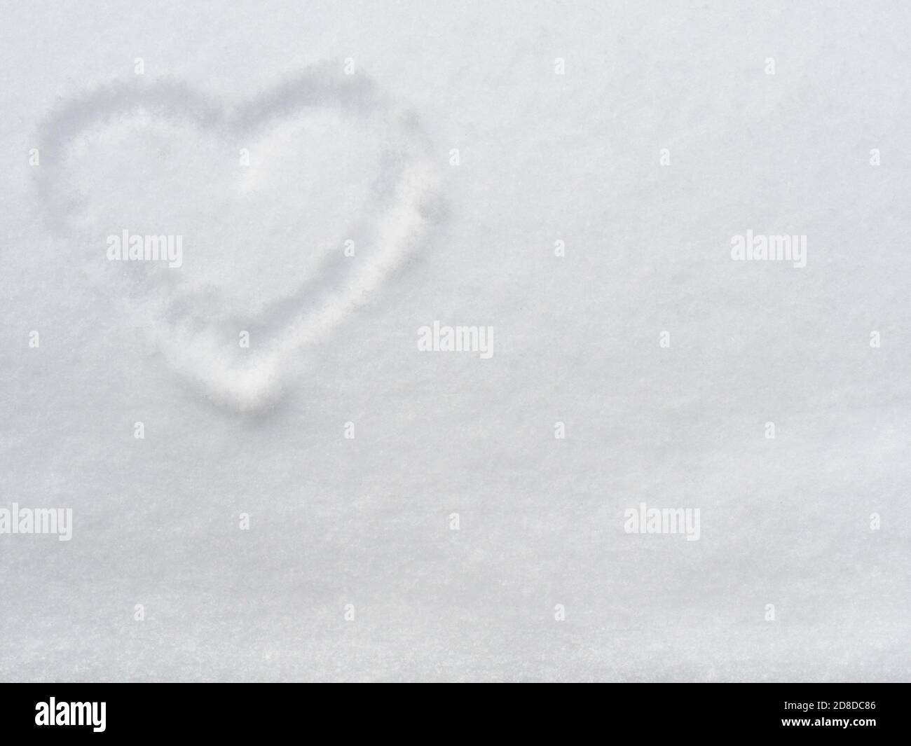 Heart shape drawn on snow, Valentine day background for love greeting card Stock Photo