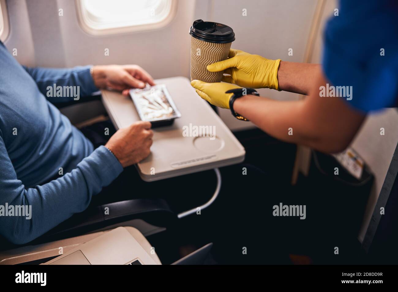 Coffee served to a passenger on the plane Stock Photo Alamy
