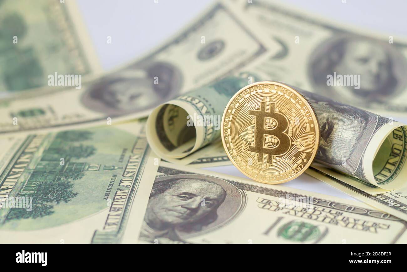 Bitcoin on banknotes of one hundred dollars. Exchange bitcoin cash for dollars Stock Photo