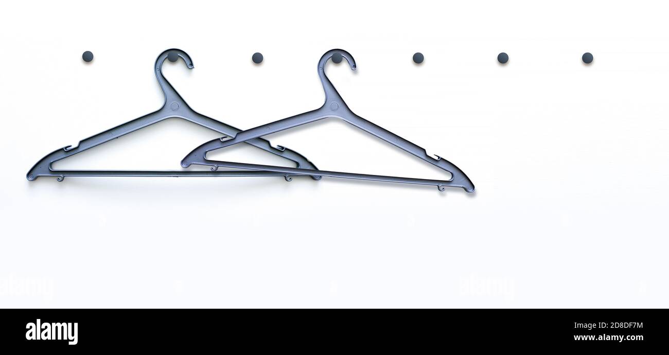 White wooden hanger hanging on a hook on a white wall Stock Photo Alamy