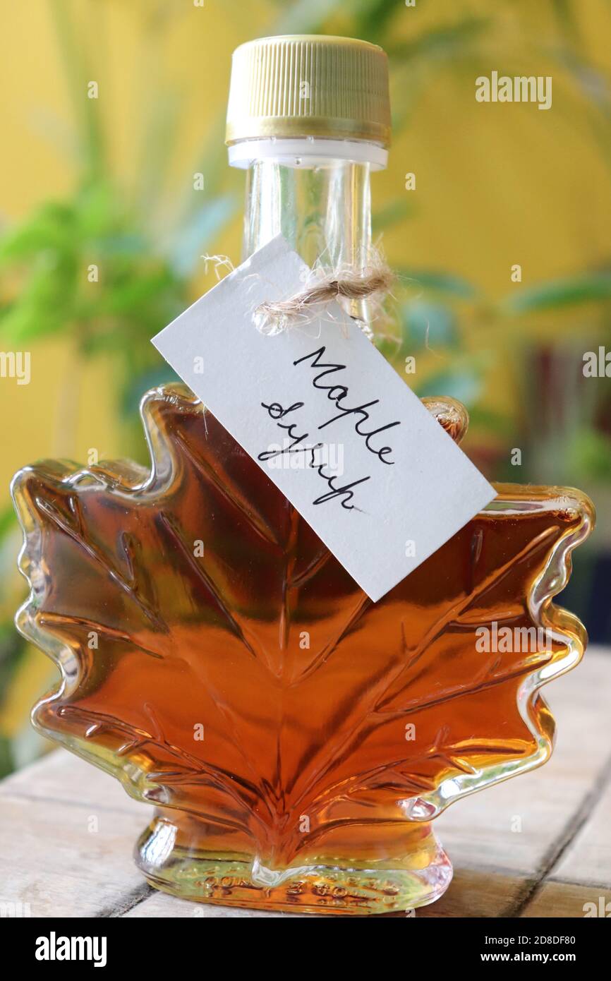 Maple syrup in a maple leaf shaped bottle,with handwritten tag/Canada