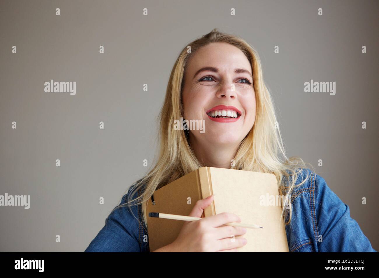 Woman thinking holding pencil hi-res stock photography and images - Alamy
