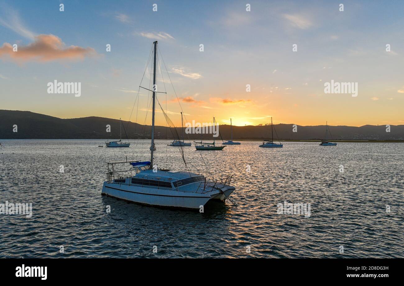 Private Boats at sunset in the Knysna Lagoon, Garden Route, South Africa Stock Photo