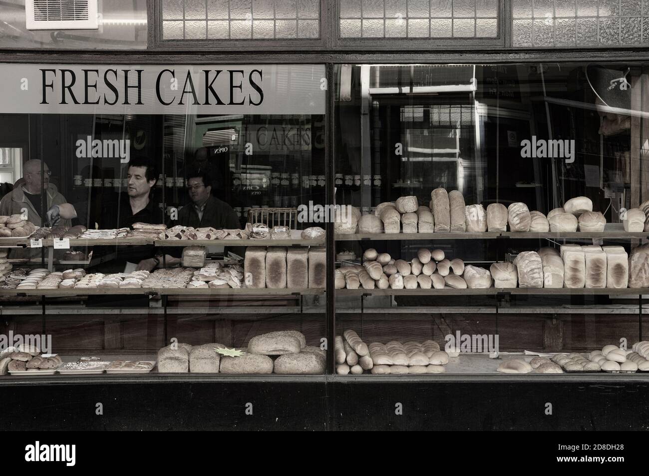 Shop window display of fresh cakes and bread at a traditional bakery