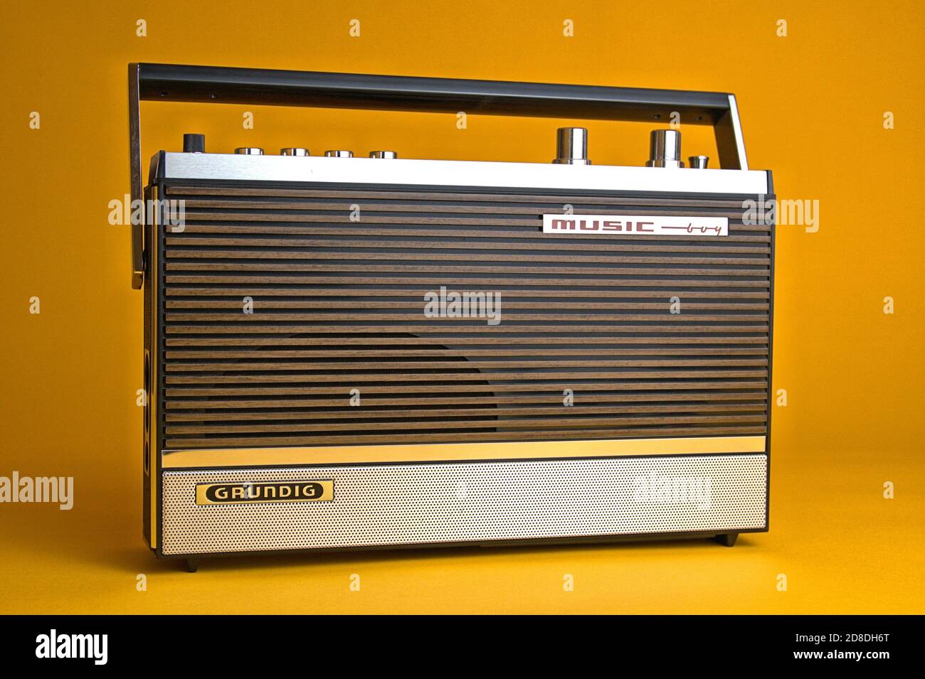 Schleswig, Deutschland. 28th Oct, 2020. An old portable radio made by  Grundig, type Music-Boy 209, which was built and sold from 1969 to 1970.  Photo against a vintage 1970s style background. The