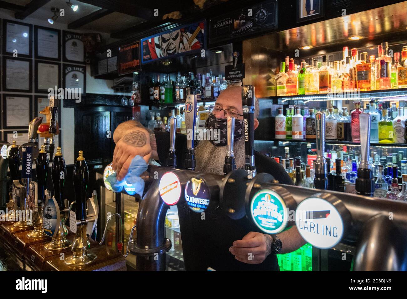 Landlord Jay Weston cleans the bar at Ye Olde Salutation Inn in Nottingham, before closing his doors when Tier 3 restrictions come into place from 0001 on Friday. Stock Photo
