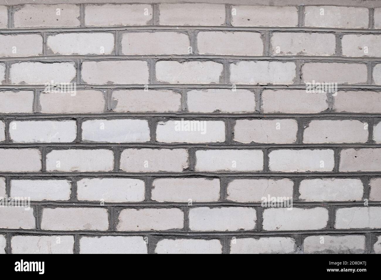 background with free space. texture of an old rough brick wall. smooth rows of light brick. stone fence made of bricks. urban vintage hipster scandy background (backdrop, surface) for graphic design. Stock Photo