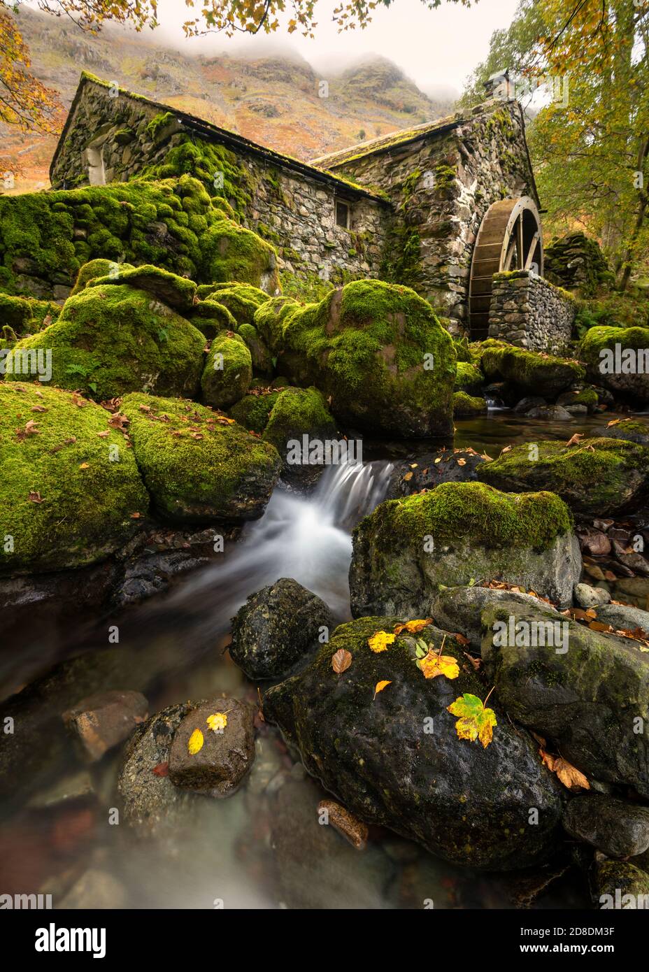 Old disused watermill with small waterfall and beautiful Autumn colours ...