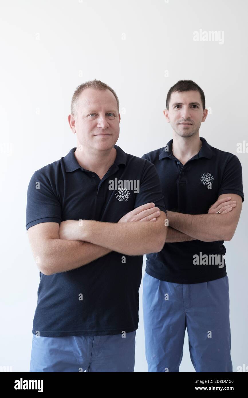 Two dentists- older and younger collegues, mentor and  student Stock Photo