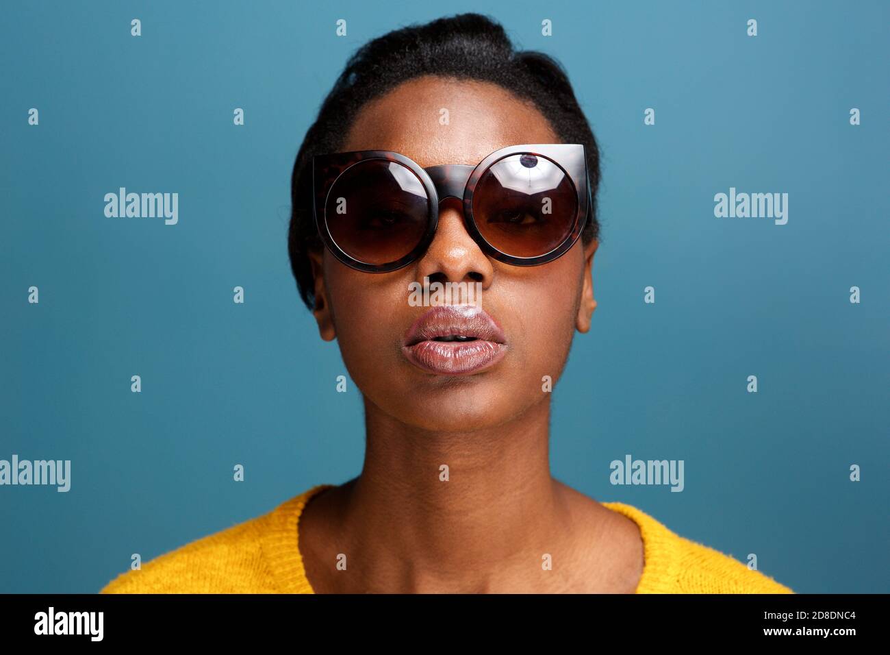 Close up front portrait of stylish young black woman in sunglasses by ...