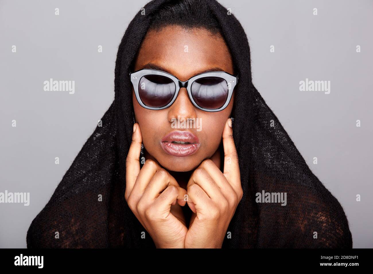 Close up portrait of beautiful black woman with headscarf and sunglasses Stock Photo