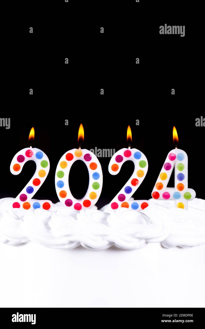Four white candles numbers flame Happy new year 2024 black background Stock Photo