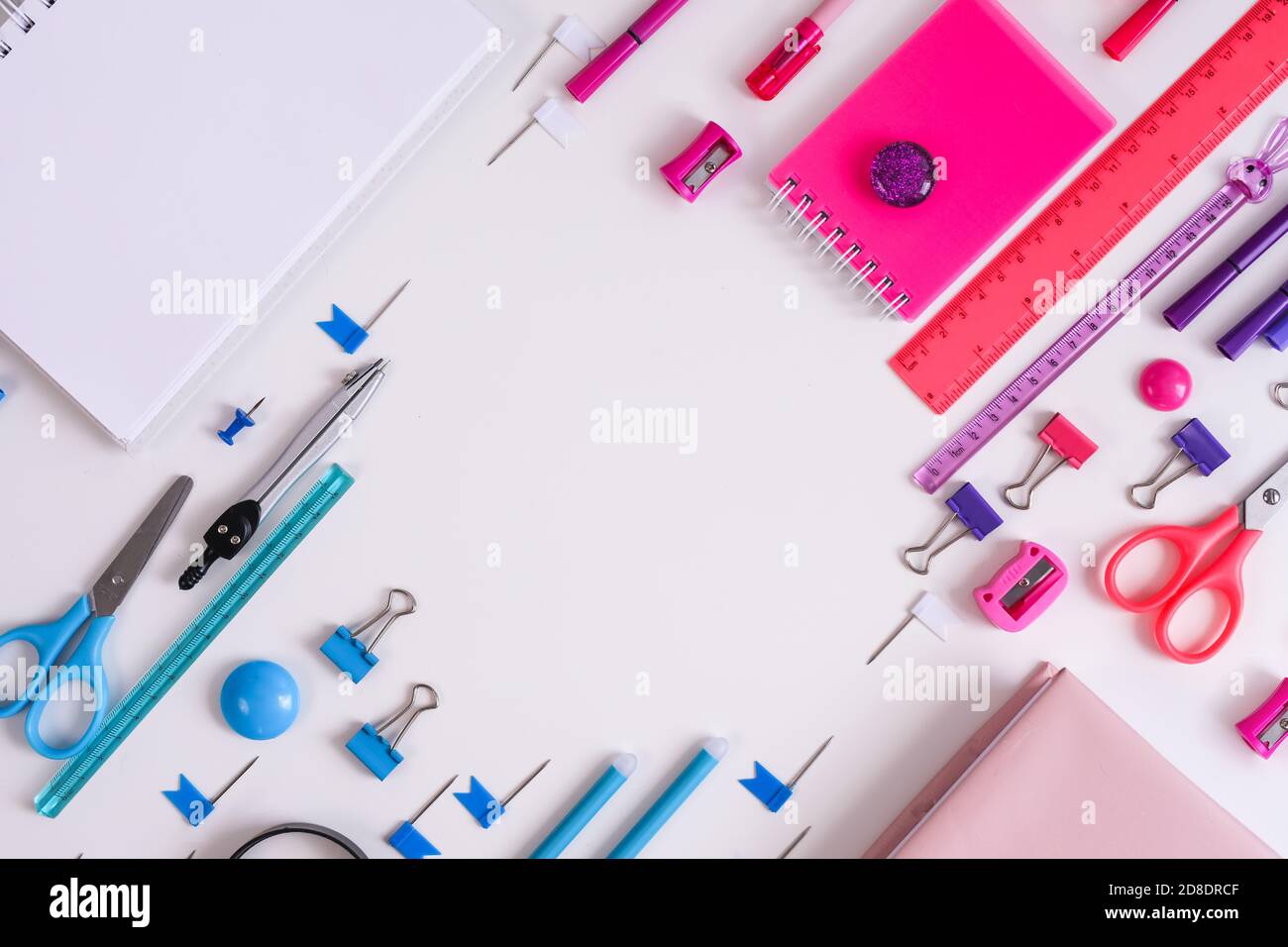 Pink notepad, pencil and marker on pink and blue background. Flat lay ...