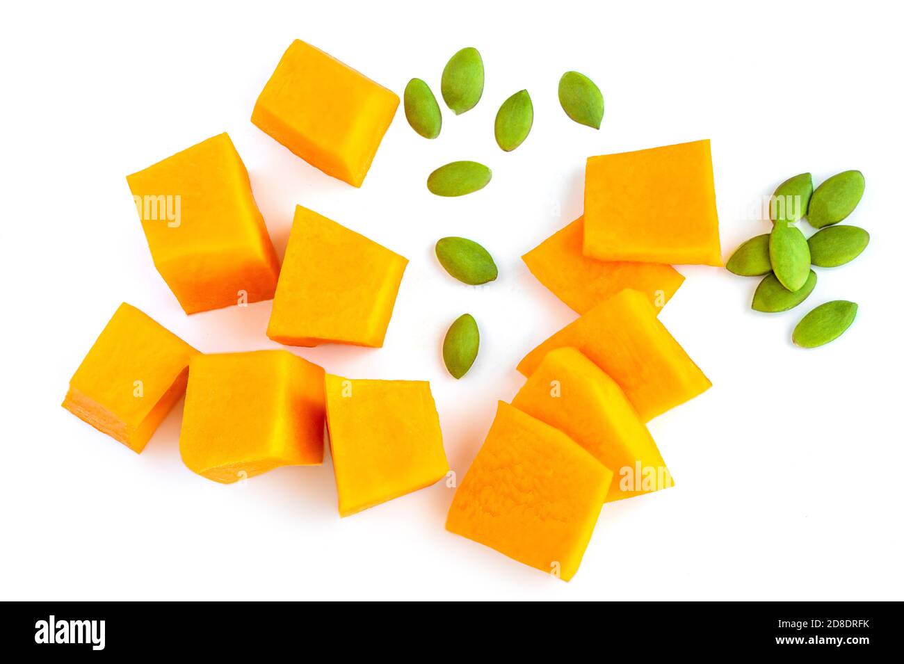 Diced Pumpkin  isolated on white background.  Pumpkin slices with seeds, top view. Flat lay Stock Photo