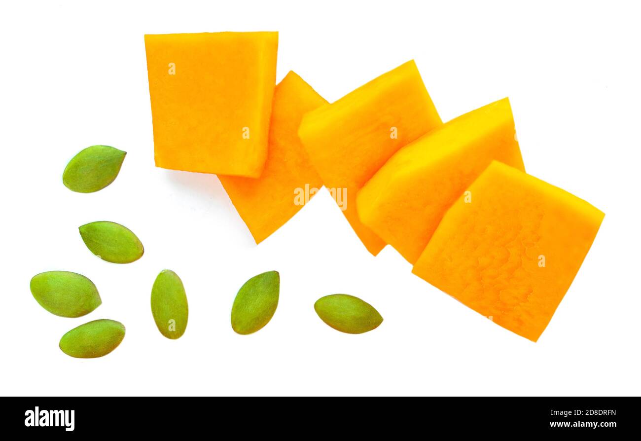 Diced Pumpkin  isolated on white background.  Pumpkin slices with seeds, top view. Flat lay Stock Photo