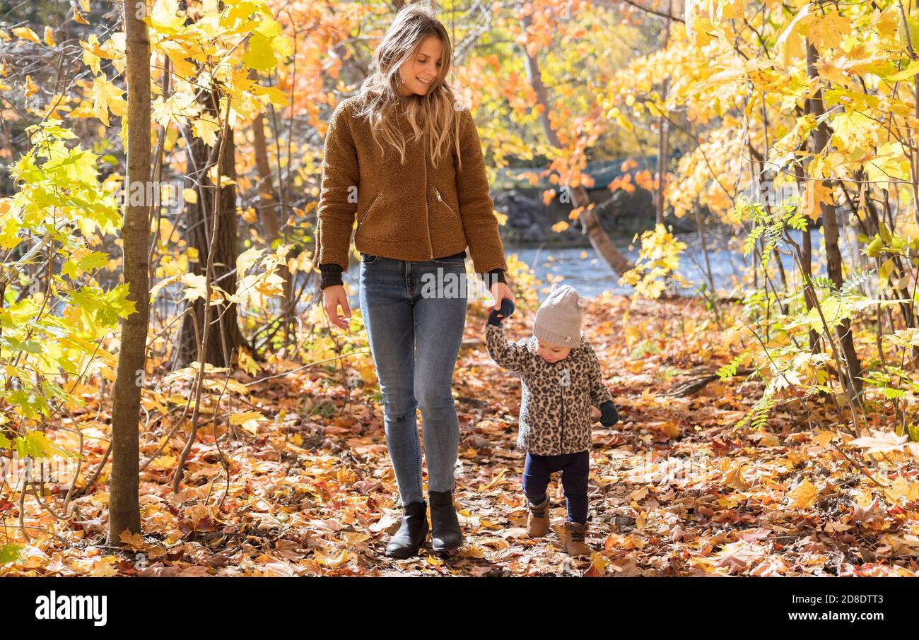 Little girl and her mother playing in the autumn park Stock Photo - Alamy