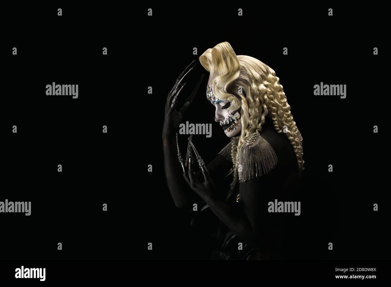 Portrait of a young woman wearing halloween makeup on a black background Stock Photo