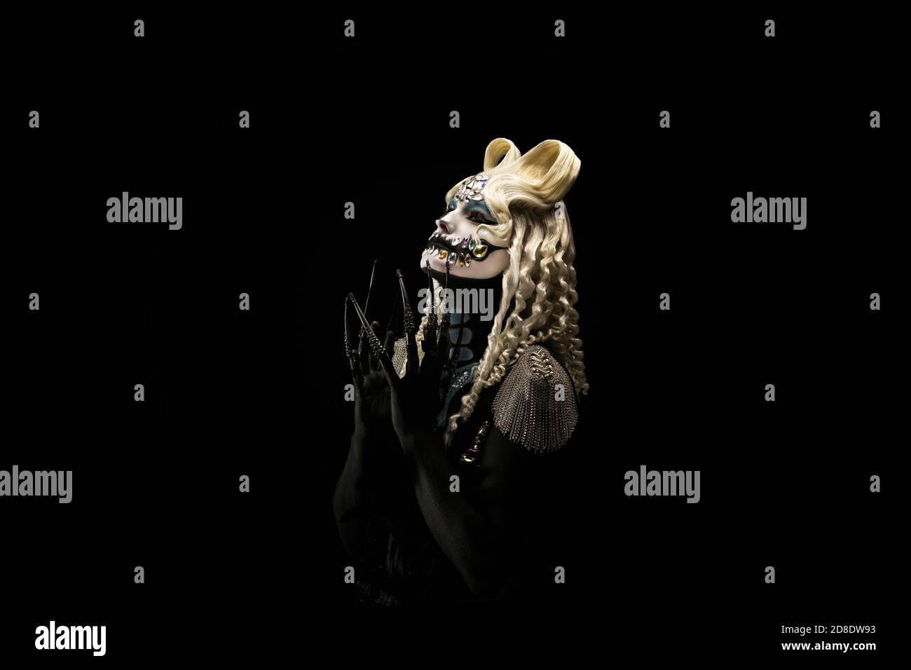 Portrait of a young woman wearing halloween makeup on a black background Stock Photo