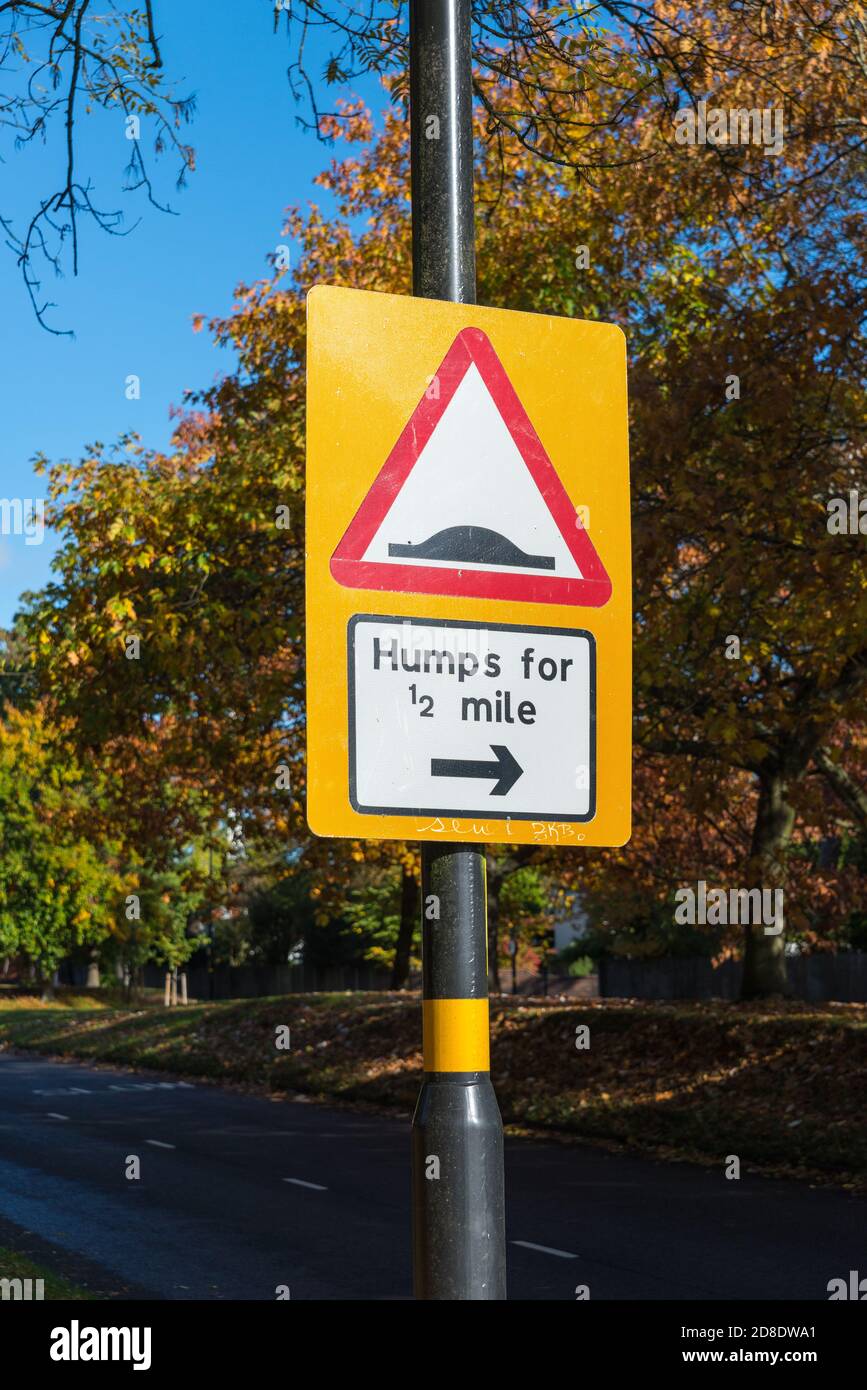 Red triangle road sign warning of humps for half a mile Stock Photo