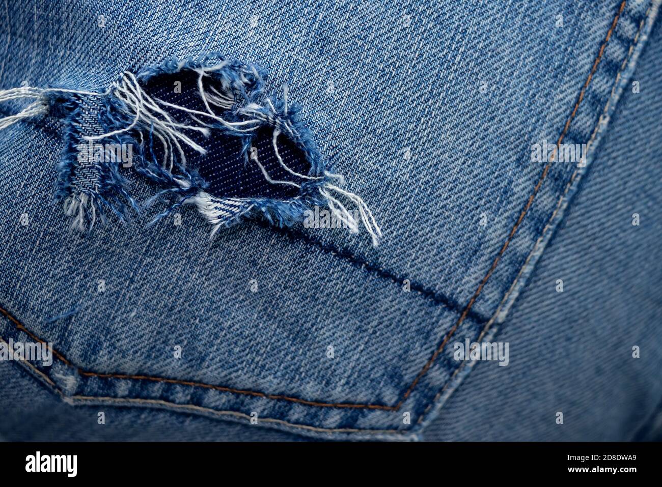 A hole in the back pocket of my jeans. Close-up Stock Photo