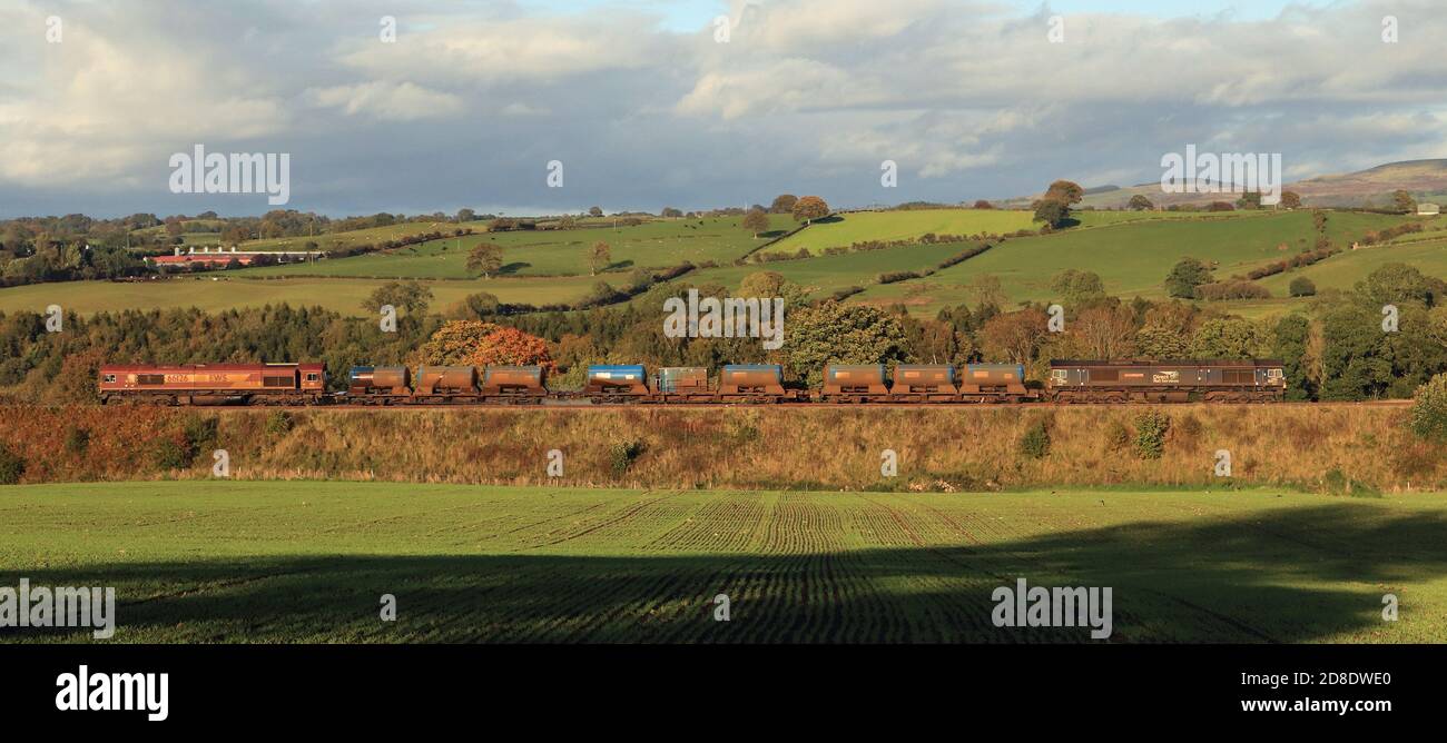 Two DRS Diesel locomotive’s on a “Leaf buster” train passing between Cumwhinton and Cotehill in the Cumbrian countryside on a sunny autumn afternoon. Stock Photo