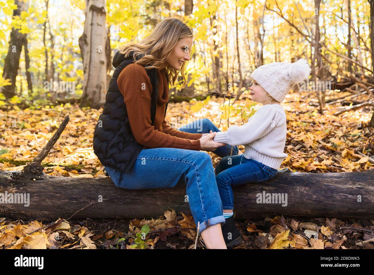 Little girl and her mother playing in the autumn park Stock Photo - Alamy