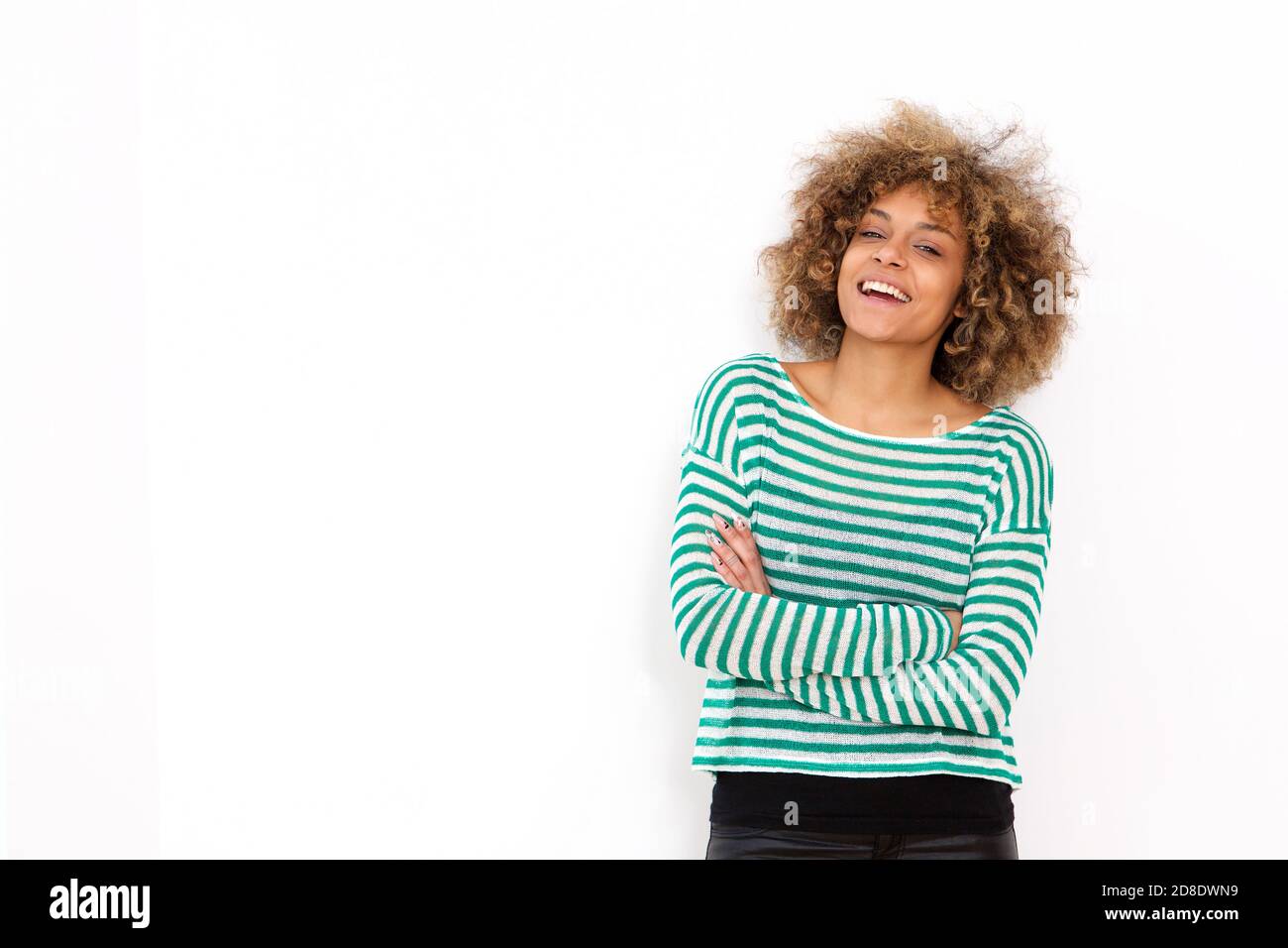 Portrait of confident young black woman smiling against white background Stock Photo