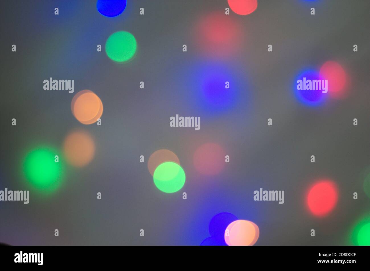 Christmas multi colored light defocused dots background on black Stock Photo