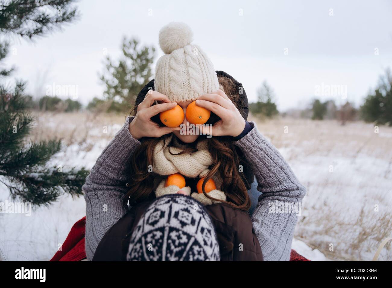 Young couple fooling around in the snow in winter.  Stock Photo
