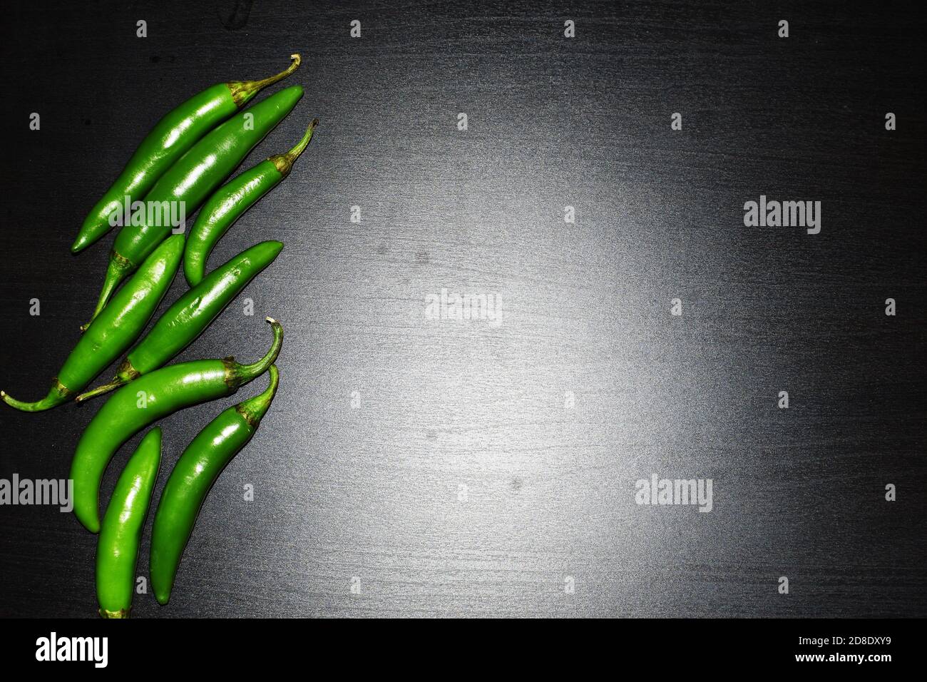 Chile serrano or serrano chilis in a black background, ingredients for Mexican food cuisine. dark food or low key light photography Stock Photo