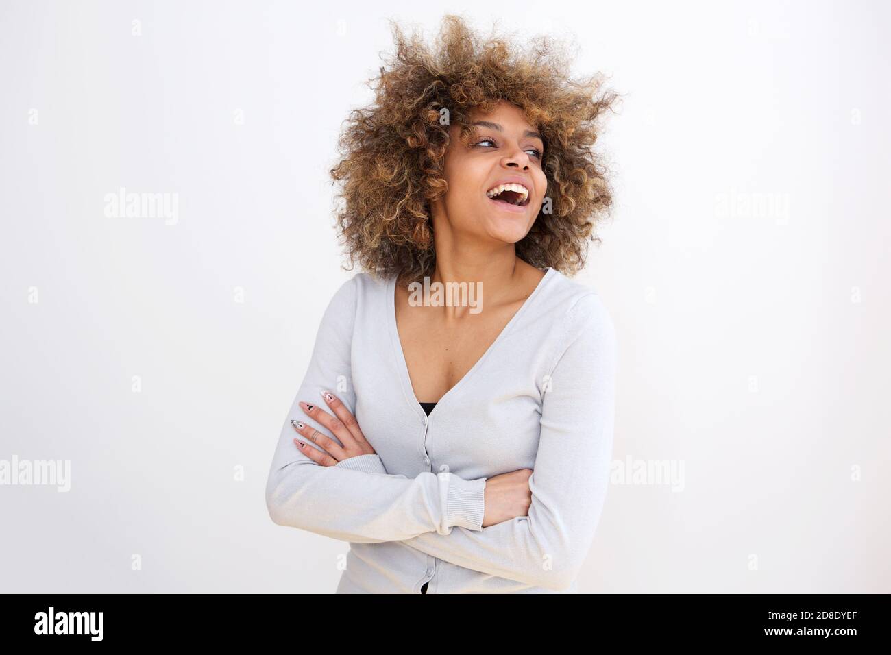 Portrait of happy young african american woman laughing against white ...